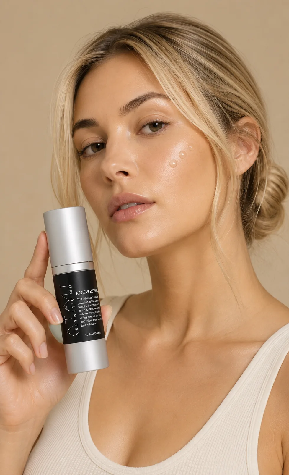 Woman holding Renew Retinol with smoother, renewed skin